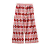 The Jessica Diamond Print Wide Leg Elastic Waist Pants by Mabel and Honey feature a pink and red diamond argyle pattern on soft knit fabric, with an elastic waistband and cropped length, displayed against a plain white background.