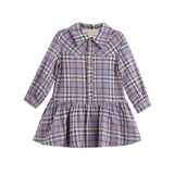 The Mabel and Honey Char Long Sleeve Plaid Collared Drop Waist Dress is a children’s dress made from soft brushed flannel. Featuring a classic plaid pattern in shades of purple, brown, and white, this lavender dress has long sleeves, a collared neckline, white buttons down the front, and a gathered drop waist skirt.