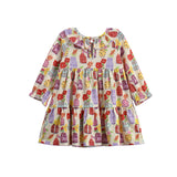 The Petal Pots Long Sleeve Print Ruffle Collar Tiered Dress by Mabel and Honey features a soft cream stretch knit fabric, a relaxed fit, and playful tiered layers. Adorned with a vibrant pattern of cupcakes, candies, bows, and touches of floral print in red, purple, and yellow, this toddler dress is finished with long sleeves and a charming ruffled collar. Displayed on a white background.
