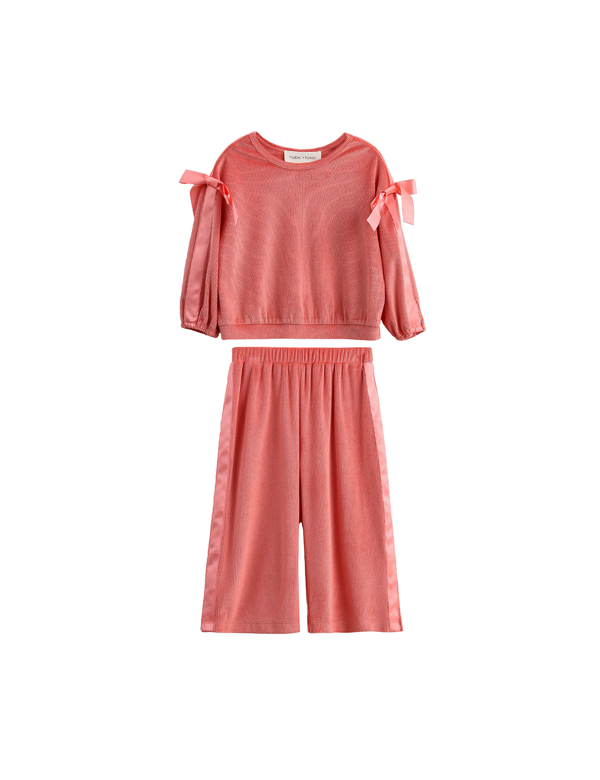 The Poppy Rose Long Sleeve Ribbed Bow Tie Top and Wide Leg Pant Set by Mabel and Honey features bow accents on the shoulders and a comfortable ribbed fabric, presented in a vibrant coral hue. This matching two-piece set includes a long sleeve top and wide-leg pants, both displayed against a white background.