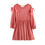 The Poppy Rose Long Sleeve Solid Ribbed Bow Tie Shoulder Dress by Mabel and Honey features a pink coral ribbed knit with a gathered waist, round neckline, and slightly puffy bishop sleeves with elasticized cuffs. Satin bows adorn each shoulder for an extra touch of charm.