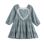 The Mabel + Honey Dolly Dress Long Sleeve Floral Tiered Heart Applique Dress is designed for kids, featuring a charming heart applique on the chest and a tiered skirt—perfect for sibling matching moments and coordinated family photos.