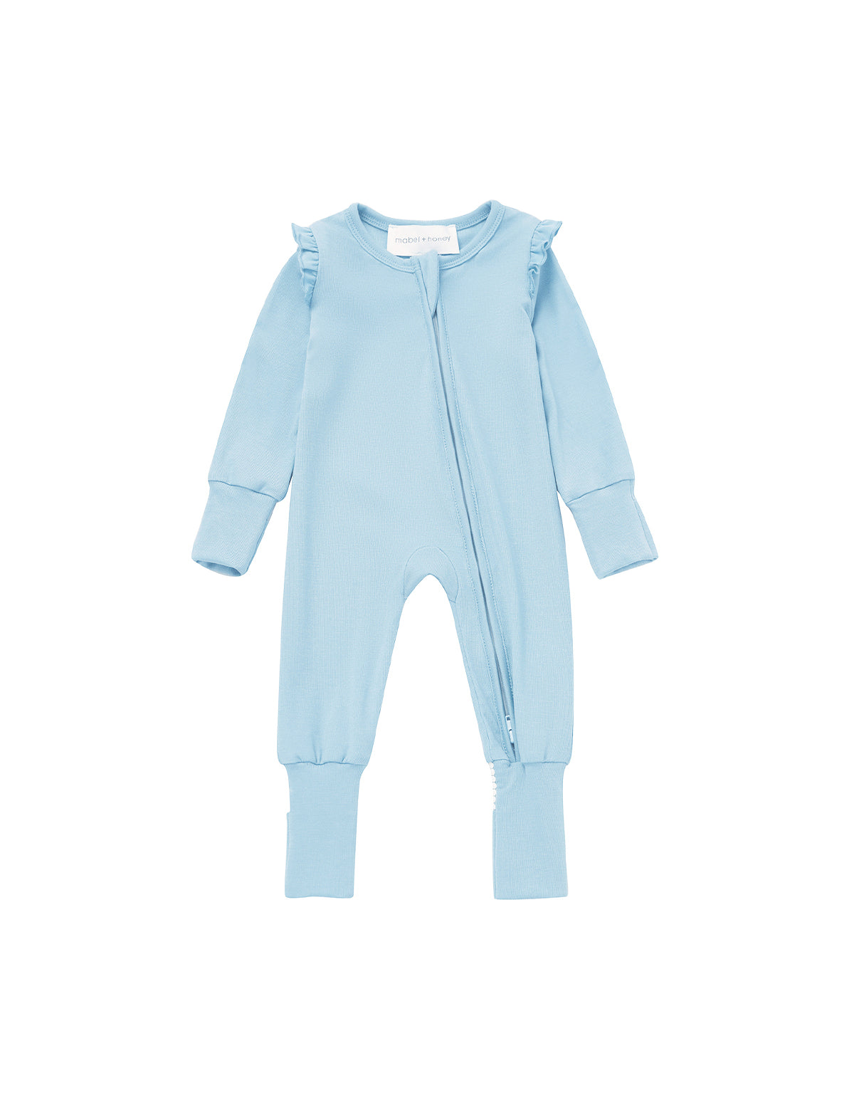 The Mabel and Honey Cactus Kisses Convertible Romper Long Sleeve Solid Straight Leg Convertible Romper, shown in light blue, is made from soft Tencel knit and features ruffled shoulders, a practical two-way zipper, and ribbed cuffs at the wrists and ankles. It is displayed on a white background.