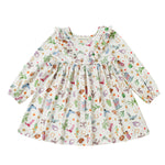The Cactus Kisses Dress Long Sleeve Print Ruffle Trim A Line Dress by Mabel and Honey features a white long-sleeve design with a ruffled neckline and a playful western-themed print of cacti, cowboy boots, hats, horseshoes, and stars.