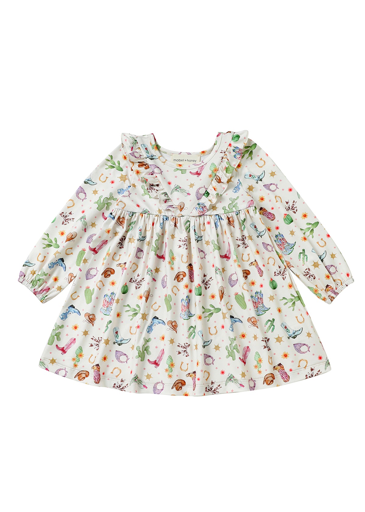 The Cactus Kisses Dress Long Sleeve Print Ruffle Trim A Line Dress by Mabel and Honey features a white long-sleeve design with a ruffled neckline and a playful western-themed print of cacti, cowboy boots, hats, horseshoes, and stars.