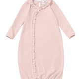 Dress your little one in the Mabel and Honey Whimsical Wildflower Long Sleeve Ruffle Trim Wrap Front Newborn Gown, featuring a soft pink hue, gentle fabric, charming ruffled trim along the front, long sleeves, and an elasticized hem for comfort. A small tag is visible at the neckline, making this gown perfect for infants.