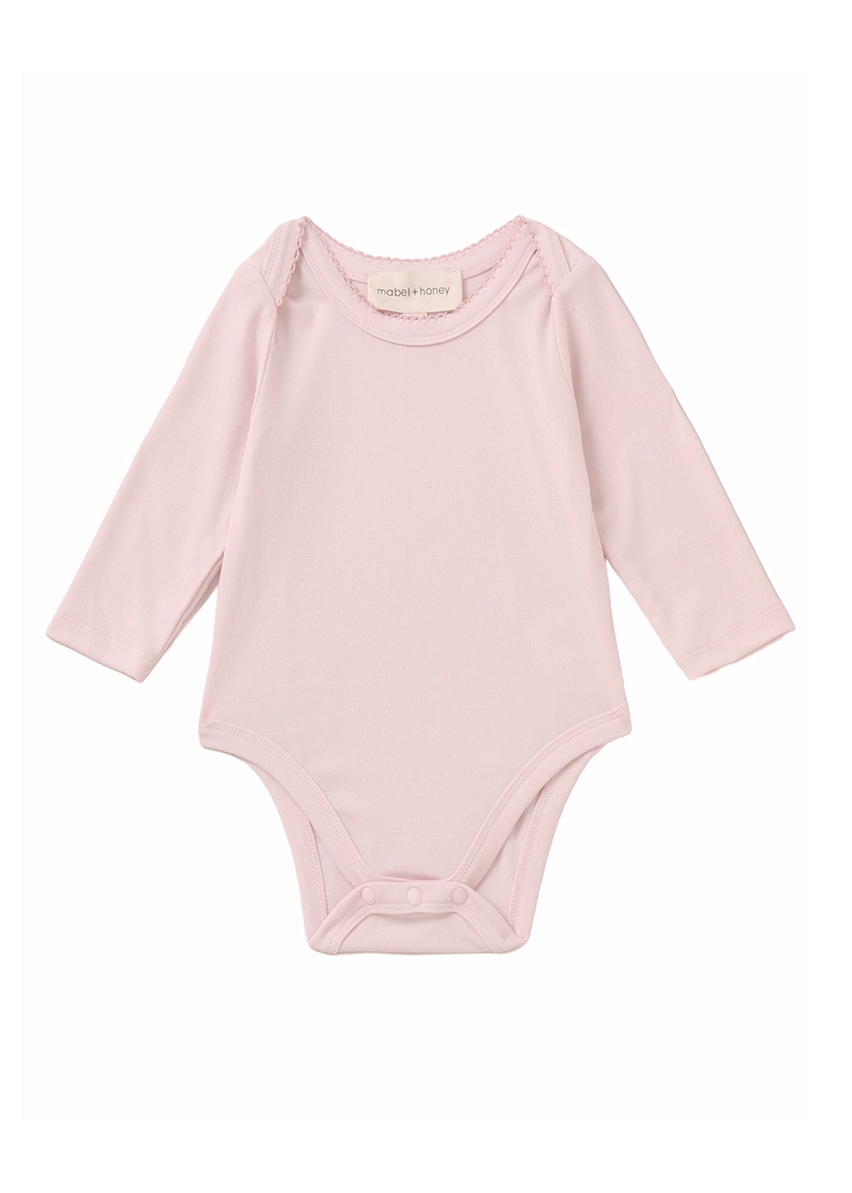The Mabel and Honey Whimsical Wildflower Long Sleeve Solid Scalloped Trim Snap Bottom Bodysuit is shown on a plain white background, featuring a light pink color, round neckline, long sleeves, scalloped trim details, and convenient snap closures at the bottom. Crafted from soft Tencel knit for gentle comfort.