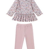 The Mabel and Honey Whimsical Wildflower Two Piece Set features a long sleeve floral peplum top with a charming ruffled hem, beautifully paired with plain light pink leggings for a sweet and stylish girls’ outfit.