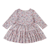 The Mabel and Honey Whimsical Wildflower Dress is a long-sleeve, knee-length A-line dress for children, showcasing a colorful wildflower print on a white background. It features a gathered waist, round neckline, and a charming ruffled tiered skirt.