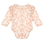 The Mabel and Honey Honey Petals Bodysuit Long Sleeve Floral Print Ruffle Shoulder Bodysuit features a charming peach floral pattern on a white background, with delicate ruffled shoulder details.
