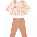 The Mabel and Honey Honey Petals Two Piece Set features a long-sleeve, ruffled floral print top in soft pastel hues paired with solid light brown leggings, both laid flat on a white background.