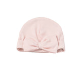 The Amelia Rose Hat Solid Ribbed Knit Bow Detail Baby Hat by Mabel + Honey is a soft pink newborn hat with an oversized bow on the front, displayed against a white background. This charming knit hat provides both comfort and style for your little one.