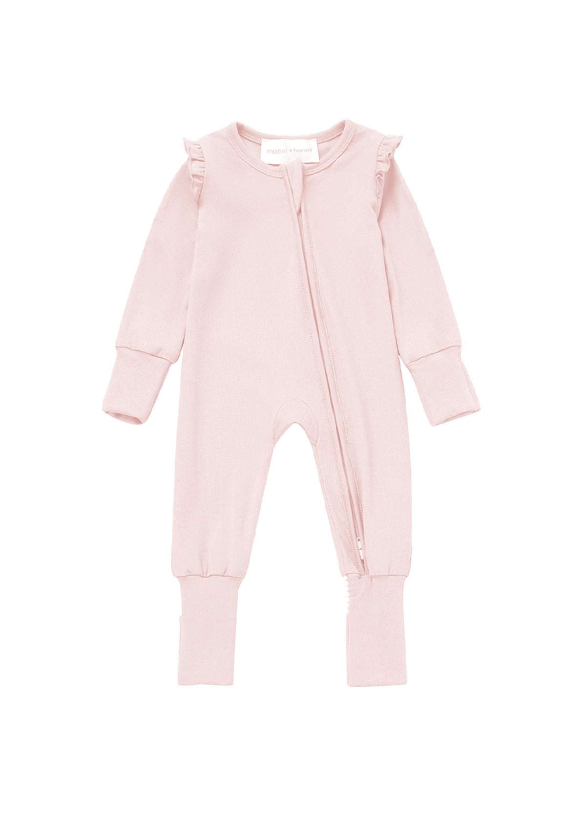The Amelia Rose Convertible Romper by Mabel + Honey is a light pink, long-sleeve baby girl romper featuring ruffle trim on the shoulders, a front zipper, and ribbed cuffs at the sleeves and legs. The footed garment is displayed laid flat on a white background.