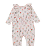 The Amelia Rose Long Sleeve Floral Ruffle Shoulder Bubble Romper by Mabel and Honey features charming ruffled shoulders, a sweet bubble silhouette, and a delicate pink, red, and green floral pattern on a soft light pink background. Made from a cozy cotton blend to keep your little one comfortable all day.