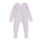 Discover cozy sleepwear with the Mabel + Honey Soft Meadow Convertible Romper: a lavender baby onesie made from soft Tencel knit, designed with long sleeves, front zipper, ruffled shoulders, and ribbed cuffs at the sleeves and ankles. This solid straight leg essential effortlessly transitions from sleepwear to a convertible romper for baby girls.