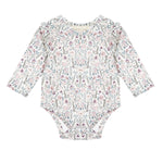 The Mabel and Honey Soft Meadow Long Sleeve Floral Ruffle Trim Bodysuit features a pastel floral pattern and ruffled shoulders, crafted from soft jersey knit and displayed flat against a white background.