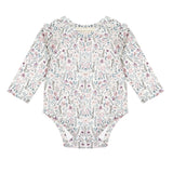 The Mabel and Honey Soft Meadow Long Sleeve Floral Ruffle Trim Bodysuit features a pastel floral pattern and ruffled shoulders, crafted from soft jersey knit and displayed flat against a white background.