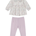 The Soft Meadow Two Piece Set by Mabel and Honey features a long-sleeve floral top with a ruffle-trimmed Peter Pan collar and coordinating purple leggings, all crafted from soft knit fabric and laid flat on a white background.