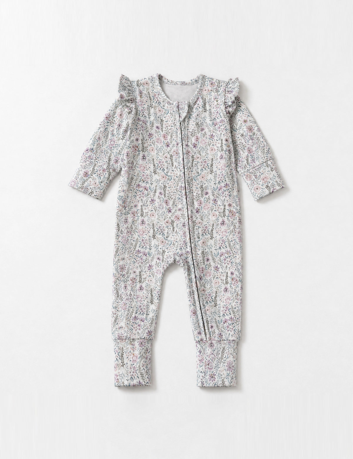 The Whimsical Wildflower Long Sleeve Floral Ruffle Shoulder Zip Front Convertible Romper by Mabel + Honey is crafted from soft stretch cotton and features a charming floral pattern, front zipper, ruffled shoulder details, convertible cuffs, and ribbed trim—displayed on a plain light background.