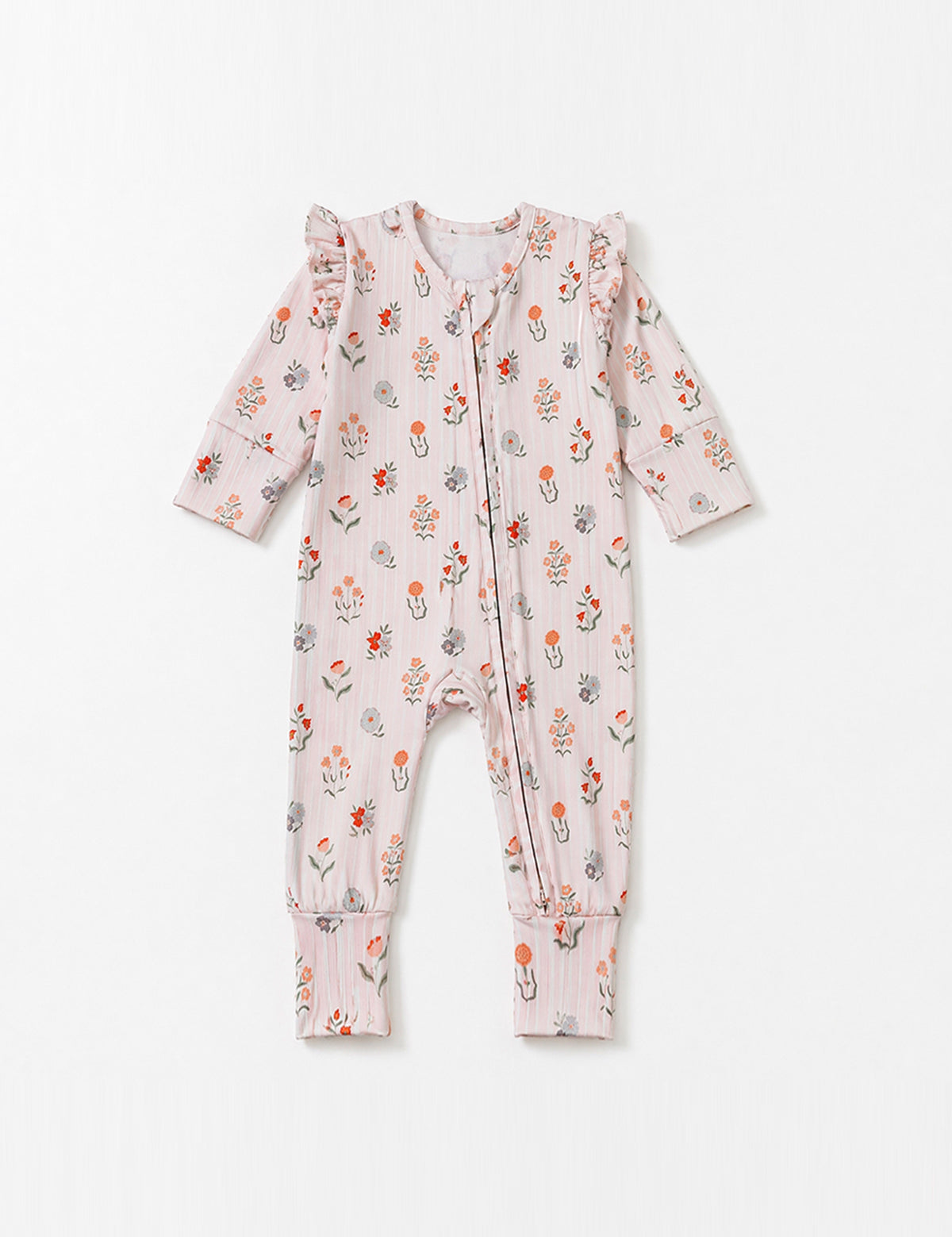 The Amelia Rose Long Sleeve Floral Ruffle Shoulder Convertible Romper by Mabel + Honey, crafted from a soft stretch knit with a pastel pink base, floral print, front zipper, ruffled shoulders, and folded cuffs, is laid flat on a plain white background.