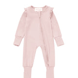 Introducing the Whimsical Wildflower Convertible Romper with Headband from Mabel + Honey—a soft light pink baby romper featuring long sleeves, ruffled shoulders, a diagonal zipper, and a convertible footed sleeper design for versatility and comfort. The set includes a matching pink fabric headband adorned with a bow displayed above the outfit.