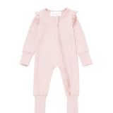 The Mabel + Honey Amelia Rose Convertible Romper features long sleeves, a zipper front, ruffled shoulders, and comes with a matching pink headband adorned with a bow, displayed flat on a white background.