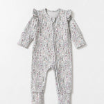 Introducing the Mabel + Honey Whimsical Wildflower Convertible Romper—this long-sleeve floral print romper features ruffled shoulders, a convenient front zipper, and a whimsical wildflower ditsy design in muted tones. The look is charmingly completed with a coordinating fabric headband placed above the romper.