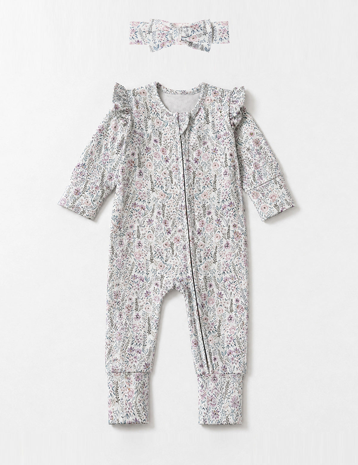 Introducing the Mabel + Honey Whimsical Wildflower Convertible Romper—this long-sleeve floral print romper features ruffled shoulders, a convenient front zipper, and a whimsical wildflower ditsy design in muted tones. The look is charmingly completed with a coordinating fabric headband placed above the romper.
