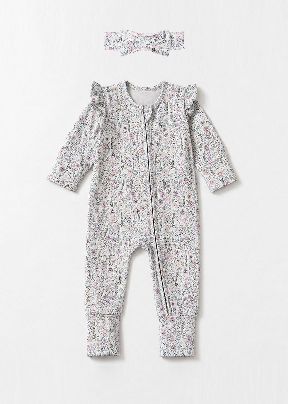 Introducing the Mabel + Honey Whimsical Wildflower Convertible Romper—this long-sleeve floral print romper features ruffled shoulders, a convenient front zipper, and a whimsical wildflower ditsy design in muted tones. The look is charmingly completed with a coordinating fabric headband placed above the romper.