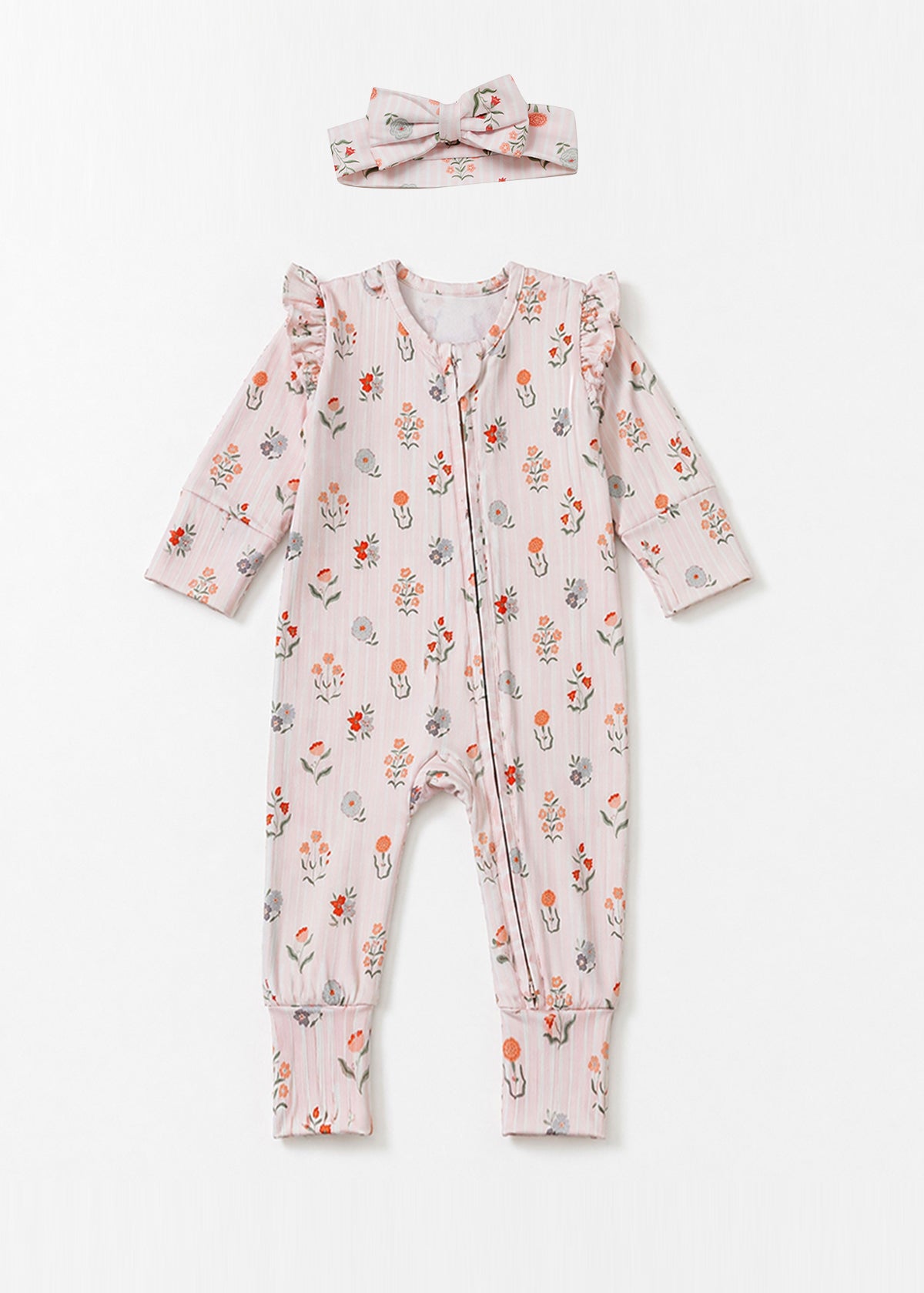 The Amelia Rose Convertible Romper by Mabel + Honey features a charming long sleeve floral print design with ruffled shoulders and comes with a matching headband, shown here laid flat on a white background.
